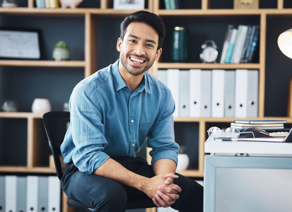 man smiling while in office